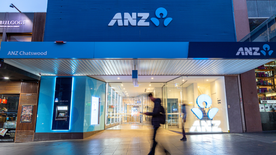 ANZ branch. Person walking past.