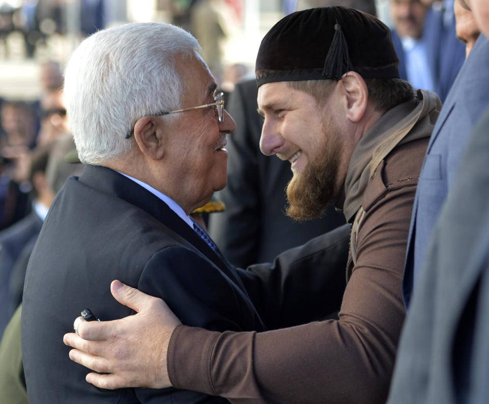 FILE - Chechen regional leader Ramzan Kadyrov, right, greets Palestinian President Mahmoud Abbas before the opening ceremony of the main mosque in Moscow, Russia, Wednesday, Sept. 23, 2015. Kadyrov, spoke strongly in support of the Palestinians, assailing Israel for capturing their lands and establishing blockades. (Alexei Druzhinin, Sputnik, Kremlin Pool Photo via AP, File)