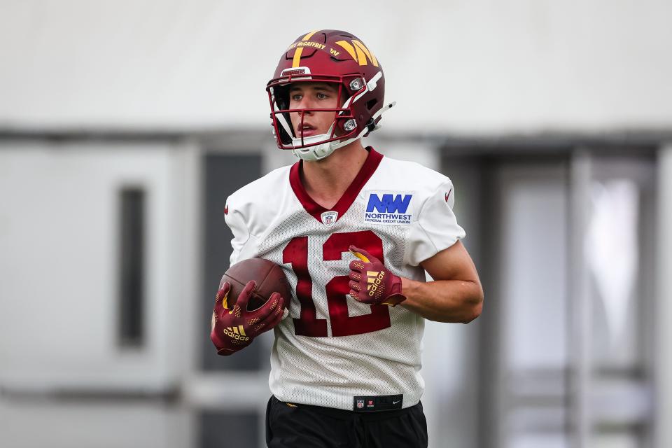 ASHBURN, VA - MAY 10: Luke McCaffrey #12 of the Washington Commanders carries the ball during Washington Commanders Rookie Minicamp at OrthoVirginia Training Center on May 10, 2024 in Ashburn, Virginia. (Photo by Scott Taetsch/Getty Images)