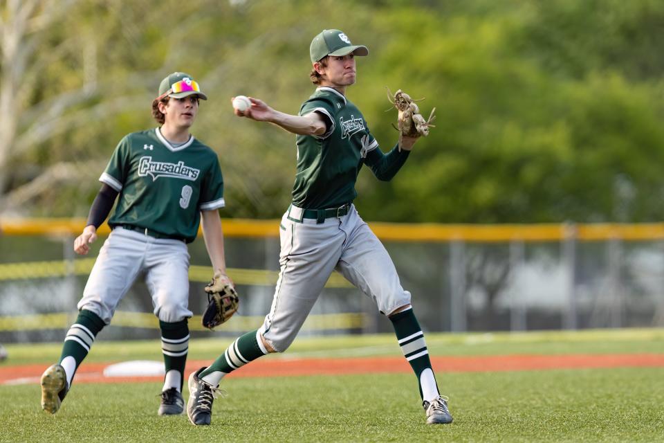 Central Catholic pitcher Dylan Rouse makes a play to first base during the OHSAA Division III district semifinal baseball game against Triway on Monday.