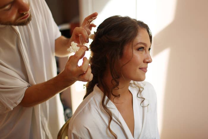 A bride gets her hair done before her wedding