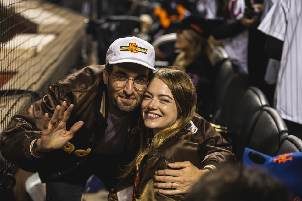 Dave McCary and Emma Stone smiling and waving