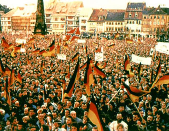 <span class="caption">Confederate flag among German flags as the Berlin Wall crumbled in 1989.</span> <span class="attribution"><span class="source">public domain</span></span>