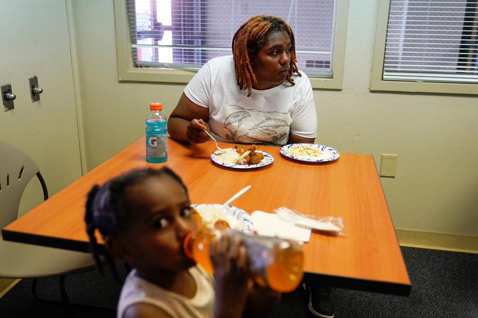 A tenant who escaped from the sixth floor after her apartment building that partially collapsed Sunday afternoon eats lunch inside a Red Cross shelter in Davenport, Iowa, on May 31, 2023. (Erin Hooley / AP)