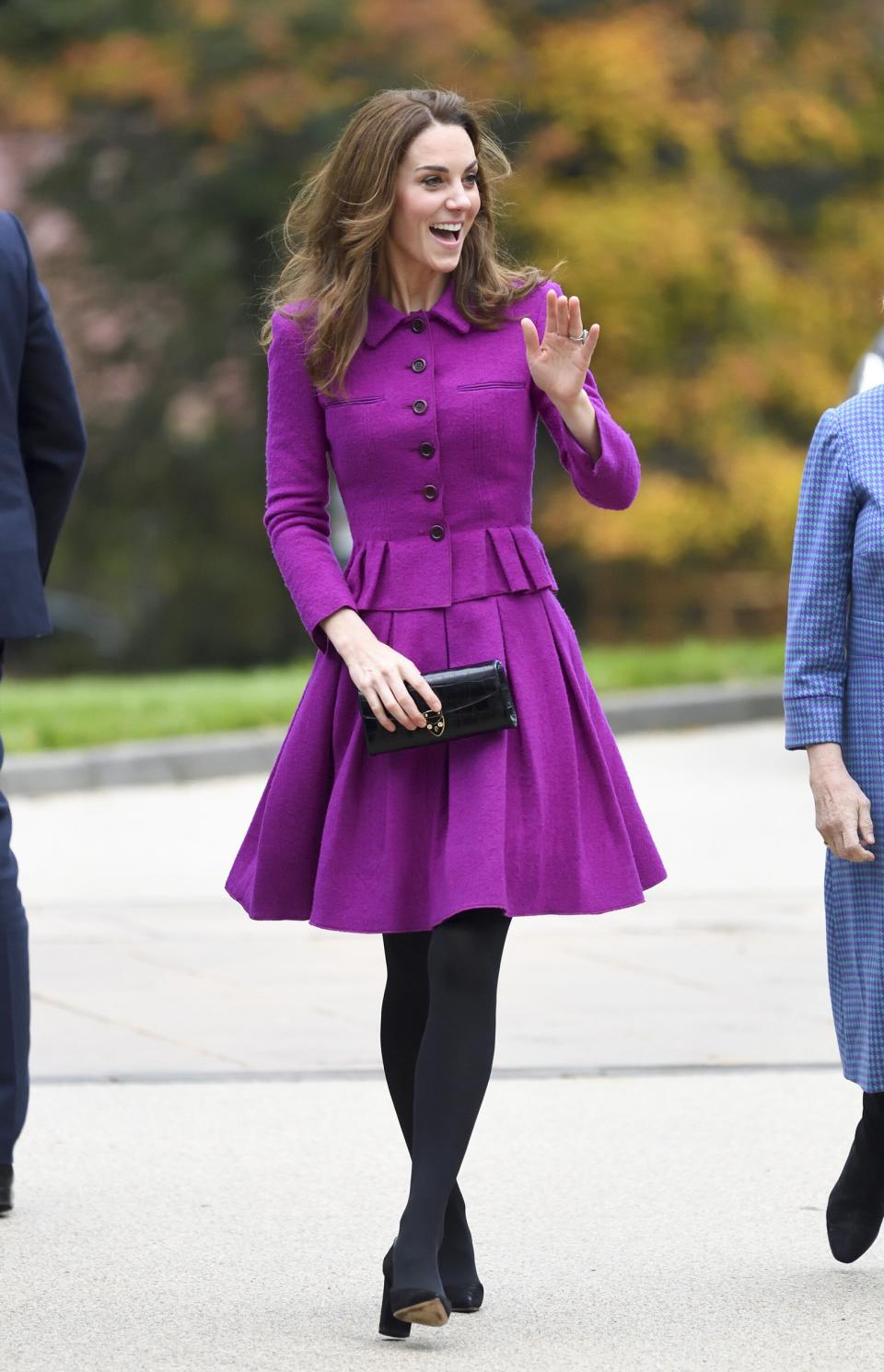 Kate Middleton <a href="https://people.com/royals/royal-purse-swap-kate-middleton-sneakily-trades-her-commuter-tote-for-her-signature-clutch/" rel="nofollow noopener" target="_blank" data-ylk="slk:stepped out in Norfolk to visit The Nook hospice;elm:context_link;itc:0;sec:content-canvas" class="link ">stepped out in Norfolk to visit The Nook hospice</a> wearing a recycled magenta skirt suit by <a href="https://click.linksynergy.com/deeplink?id=93xLBvPhAeE&mid=1237&murl=https%3A%2F%2Fshop.nordstrom.com%2Fbrands%2Foscar-de-la-renta--1060&u1=PEO%2CShopping%3AEverythingYouNeedtoCopyKateMiddleton%E2%80%99sChicWinterStyle%2Ckamiphillips2%2CUnc%2CGal%2C7360903%2C202002%2CI" rel="nofollow noopener" target="_blank" data-ylk="slk:Oscar de la Renta;elm:context_link;itc:0;sec:content-canvas" class="link ">Oscar de la Renta</a>, black tights, and a pair of black pumps. She even traded in her black commuter tote upon arrival for a chic Aspinal x Beulah clutch. <strong>Get the Look!</strong> Harper Rose Bell Sleeve Bateau Neck Sheath Dress, $148; <a href="https://click.linksynergy.com/deeplink?id=93xLBvPhAeE&mid=1237&murl=https%3A%2F%2Fshop.nordstrom.com%2Fs%2Fharper-rose-bell-sleeve-bateau-neck-sheath-dress%2F5137872%2Ffull&u1=PEO%2CShopping%3AEverythingYouNeedtoCopyKateMiddleton%E2%80%99sChicWinterStyle%2Ckamiphillips2%2CUnc%2CGal%2C7360903%2C202002%2CI" rel="nofollow noopener" target="_blank" data-ylk="slk:nordstrom.com;elm:context_link;itc:0;sec:content-canvas" class="link ">nordstrom.com</a> Donna Morgan V-Neck Fit and Flare Crepe Dress, $118; <a href="http://www.anrdoezrs.net/links/8029122/type/dlg/sid/PEO,Shopping:EverythingYouNeedtoCopyKateMiddleton’sChicWinterStyle,kamiphillips2,Unc,Gal,7360903,202002,I/https://www.zappos.com/p/donna-morgan-v-neck-fit-and-flare-crepe-dress-orchid/product/9291191/color/1392" rel="nofollow noopener" target="_blank" data-ylk="slk:zappos.com;elm:context_link;itc:0;sec:content-canvas" class="link ">zappos.com</a> Tommy Hilfiger Women's Belted Fit and Flare Midi, $36.88–$160.32; <a href="https://www.amazon.com/Tommy-Hilfiger-Womens-Belted-Magenta/dp/B07V7199GB/ref=as_li_ss_tl?dchild=1&keywords=magenta+fit+and+flare+dress+women&qid=1574099694&sr=8-29&linkCode=ll1&tag=poamzfkatemiddletonfallstylekphillips1119-20&linkId=69435cad97116080705c8cb3416831f6&language=en_US" rel="nofollow noopener" target="_blank" data-ylk="slk:amazon.com;elm:context_link;itc:0;sec:content-canvas" class="link ">amazon.com</a> Milly Gina Silk-Blend Wrap Dress, $487.50 (orig. $650); <a href="https://click.linksynergy.com/deeplink?id=93xLBvPhAeE&mid=13867&murl=https%3A%2F%2Fwww.bloomingdales.com%2Fshop%2Fproduct%2Fmilly-gina-silk-blend-wrap-dress%3FID%3D3441620&u1=PEO%2CShopping%3AEverythingYouNeedtoCopyKateMiddleton%E2%80%99sChicWinterStyle%2Ckamiphillips2%2CUnc%2CGal%2C7360903%2C202002%2CI" rel="nofollow noopener" target="_blank" data-ylk="slk:bloomingdales.com;elm:context_link;itc:0;sec:content-canvas" class="link ">bloomingdales.com</a> Miusol Business Retro Ruffles 2/3 Sleeve Cocktail Pencil Dress, $29.99; <a href="https://www.amazon.com/Miusol-Womens-Ruffles-Business-B-Magenta/dp/B07K3PFT1D/ref=as_li_ss_tl?dchild=1&keywords=magenta+long+sleeve+dress+women&qid=1574099613&sr=8-17&linkCode=ll1&tag=poamzfkatemiddletonfallstylekphillips1119-20&linkId=215c9d80e4231738909a701329253f08&language=en_US" rel="nofollow noopener" target="_blank" data-ylk="slk:amazon.com;elm:context_link;itc:0;sec:content-canvas" class="link ">amazon.com</a>