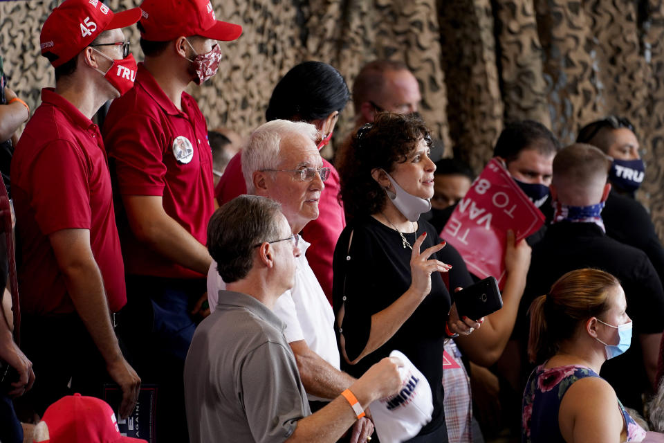 Guests try to keep cool while waiting on President Donald Trump to speak to a crowd of supporters at the Yuma International Airport Tuesday, Aug. 18, 2020, in Yuma, Ariz. (AP Photo/Matt York)