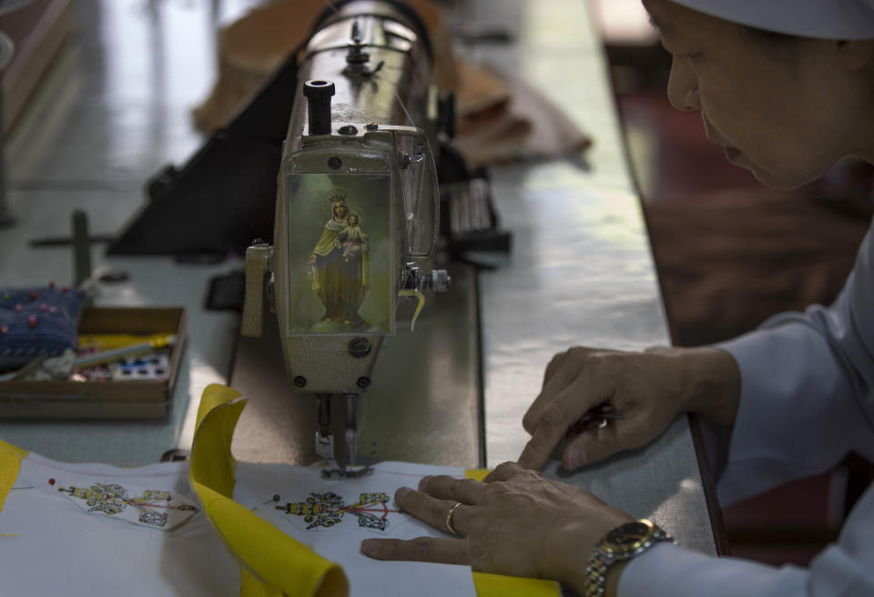 In this Friday, Nov. 8, 2019 photo, a seamstresses from the Congregation of the Sacred Heart of Jesus Sisters of Bangkok sews at a Catholic preparatory school in Bangkok, Thailand. The seamstresses have been working tirelessly, running up the ceremonial garments Pope Francis will wear during his four-day visit to Thailand later this month. (AP Photo/Gemunu Amarasinghe)