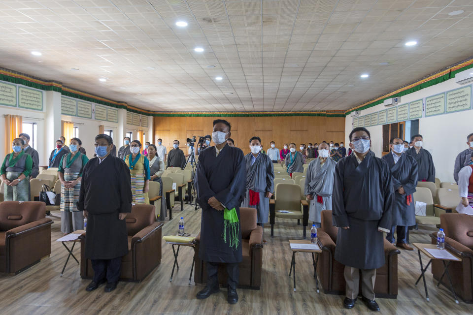 President of the Central Tibetan Administration Penpa Tsering, center front, stands up with other government officials for the Tibetan national anthem during a ceremony to mark the 86th birthday of their spiritual leader the Dalai Lama in Dharmsala, India, Tuesday, July 6, 2021. (AP Photo/Ashwini Bhatia)