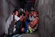 <p>Drug suspects are shown detained in a small secret cell behind a wooden cabinet, April 27, 2017, in Manila, Philippines. The commission on Human Rights raided a Manila police station to uncover a space of about 3 feet by 15 feet, where dozens of drug suspects, including three women, were detained for a week and allegedly brought out to be beaten or tortured, according to reports. The detainees allege they were kept inside the cramped cell without window, ventilation or lights for days, with no charges filed against them, while waiting for relatives to come up with at least $1,000, paid to police, in exchange for their release. (Jes Aznar/Getty Images) </p>