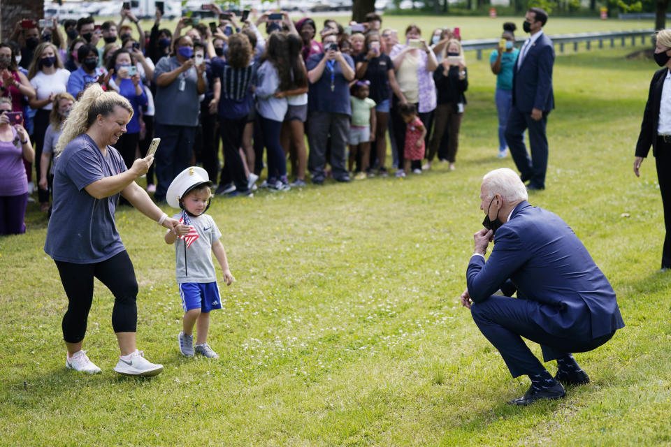 President Joe Biden stops outside at York High School and is greeted by a child and his mother, Monday, May 3, 2021, in Yorktown, Va. (AP Photo/Evan Vucci)