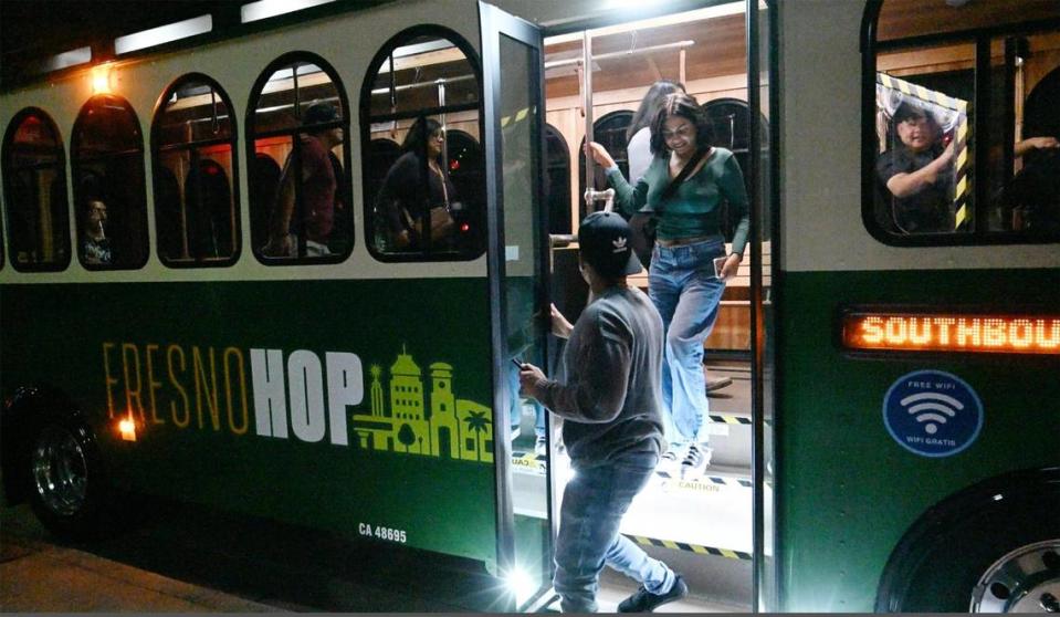 Passengers disembark the City of Fresno’s new free FresnoHOP trolley service Friday night, Nov. 10, 2023 in Fresno. The new service will leave every hour on the hour from two key locations, the Tower District and Campus Pointe on Thursdays from 5pm-12am and Fridays and Saturdays from 5pm-1am.