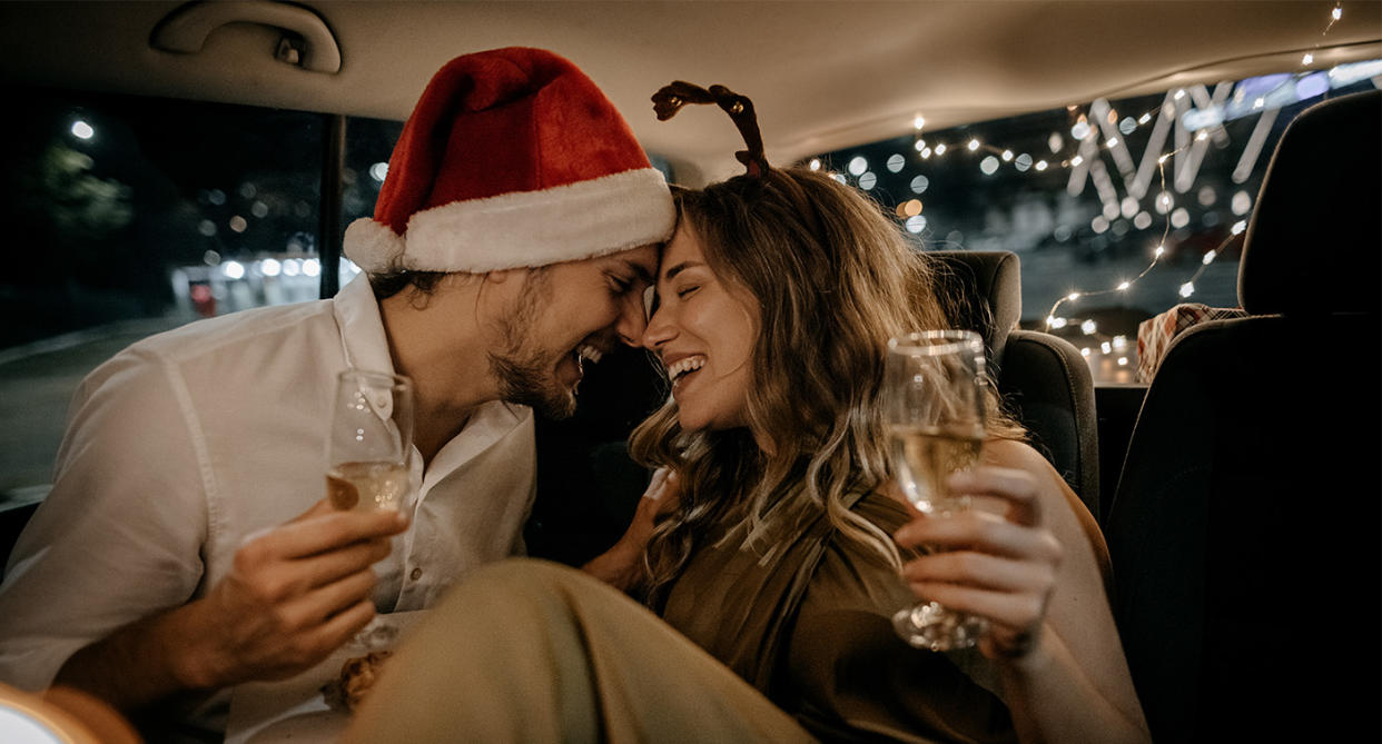 Man and woman in cab home from Christmas party, to represent one-night stand. (Getty Images)