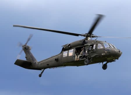 U.S. army soldiers get ready to land from Black Hawk helicopter during Suwalki gap defence exercise in Mikyciai, Lithuania, June 17, 2017. REUTERS/Ints Kalnins