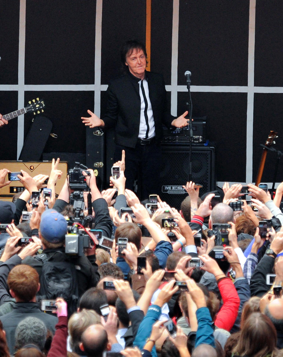 Paul McCartney and his band give a surprise pop up concert in Times Square on Thursday, Oct. 10, 2013 in New York. McCartney will release his new album called "New" on October 15th. (Photo by Evan Agostini/Invision/AP)