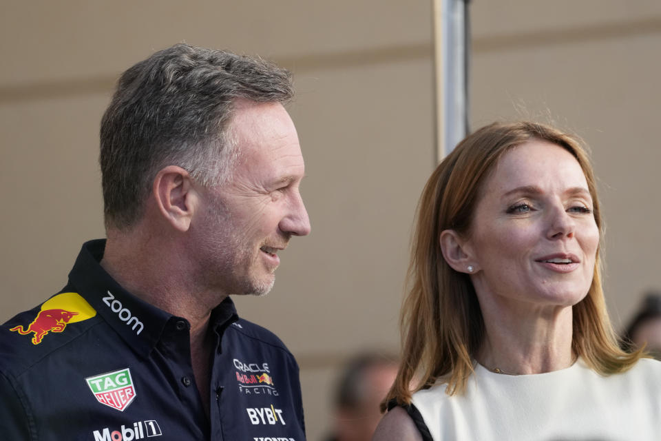 Red Bull team principal Christian Horner, left, walks with his wife Geri Halliwell prior to the Formula One Bahrain Grand Prix at the Bahrain International Circuit in Sakhir, Bahrain, Saturday, March 2, 2024. (AP Photo/Darko Bandic)