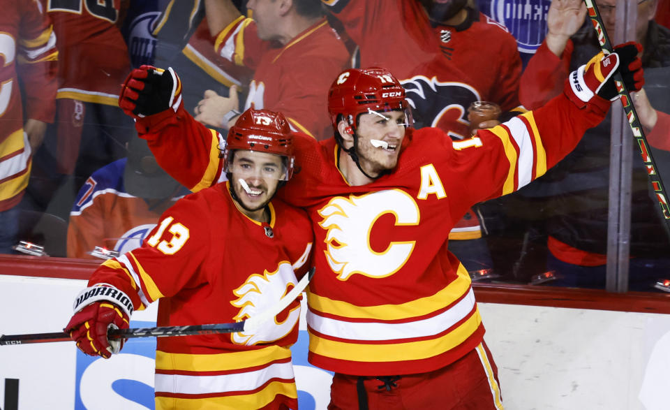 Calgary Flames forward Matthew Tkachuk, right, celebrates his goal against the Edmonton Oilers with forward Johnny Gaudreau during the third period of Game 1 of an NHL hockey second-round playoff series Wednesday, May 18, 2022, in Calgary, Alberta. (Jeff McIntosh/The Canadian Press via AP)