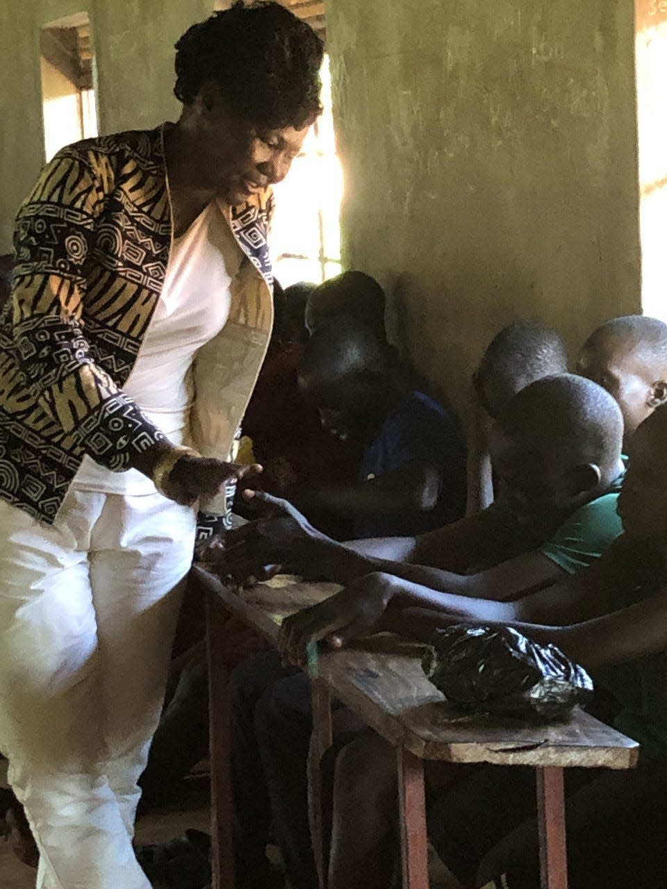 Jane Ekayu with participants in the Children of Peace Uganda center in Uganda.