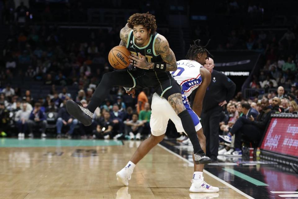 Mar 17, 2023; Charlotte, North Carolina, USA; Charlotte Hornets guard Kelly Oubre Jr. (12) keeps the ball away from Philadelphia 76ers guard Tyrese Maxey (0) during the first half at Spectrum Center. Mandatory Credit: Brian Westerholt-USA TODAY Sports (NBA News)