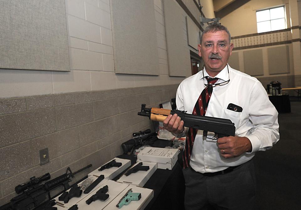 Spartanburg County Sheriff Chuck Wright said Rolling Thunder -- an annual, multi-agency enforcement push headed by Wright's office -- is an effective way to crack down on interstate crime. Wright holds one of the weapons taken during Rolling Thunder. [ALEX HICKS JR./Spartanburg Herald-Journal]