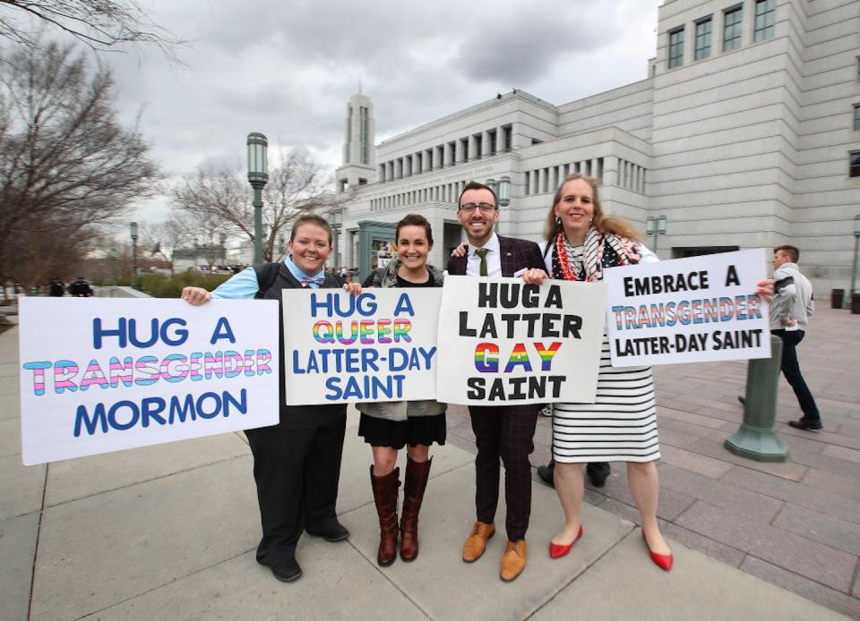 Activists outside the General Conference of the Church of Jesus Christ of Latter-day Saints in 2019. <a href="https://www.gettyimages.com/detail/news-photo/mormons-pose-for-a-picture-and-hold-signs-outside-the-news-photo/1135413792?phrase=lgbtq%20mormon&adppopup=true" rel="nofollow noopener" target="_blank" data-ylk="slk:George Frey/Getty Images;elm:context_link;itc:0;sec:content-canvas" class="link ">George Frey/Getty Images</a>