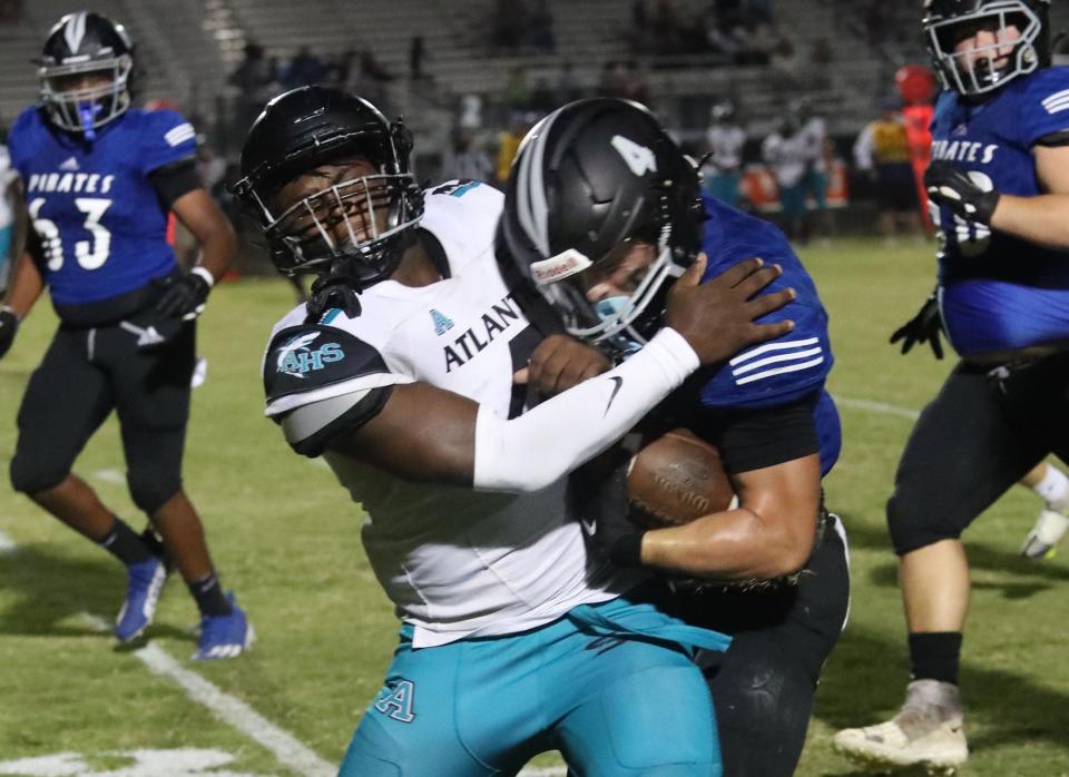 Matanzas High's Cole Hash #4 and Atlantic High tackler Jah'meen Rolle #4 meet witrh a loud thud, Friday September 22, 2023.