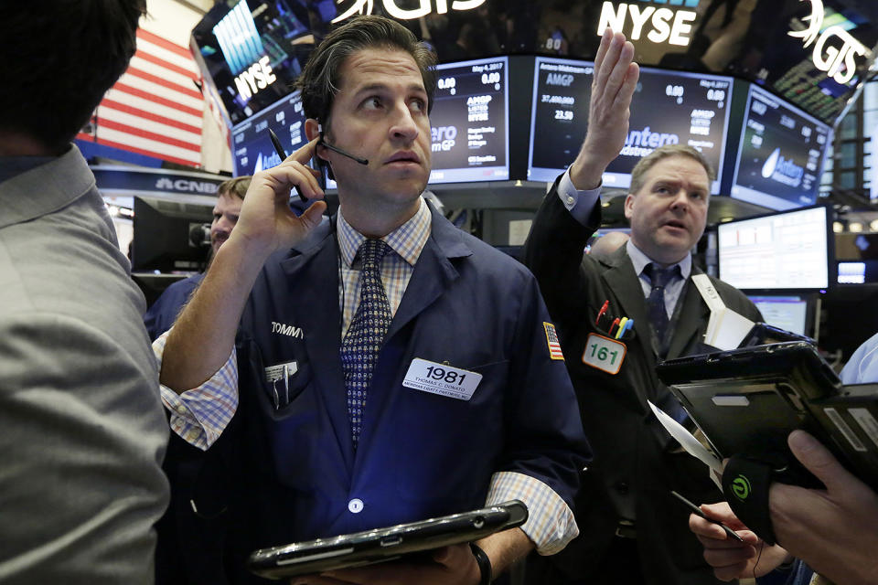 <p>Trader Thomas Donato, left, works on the floor of the New York Stock Exchange, May 4, 2017. U.S. stocks were relatively flat Thursday as oil prices continued to drop and energy companies took sharp losses. (Photo: Richard Drew/AP) </p>