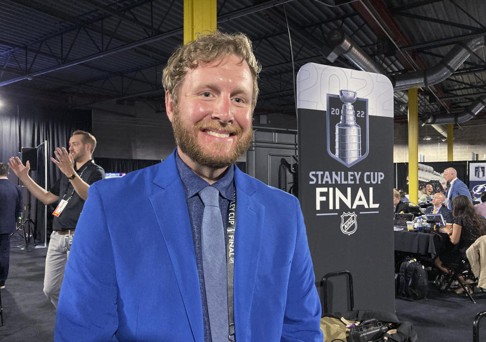 FILE - Brice Christianson poses for a photo after interpreting NHL Commissioner Gary Bettman's annual state of the league news conference from English into American Sign Language, June 15, 2022, at Ball Arena in Denver before Game 1 of the NHL hockey Stanley Cup Final. The NHL will become the first major sports league to provide a full game broadcast in American Sign Language to serve the Deaf community. The league is unveiling broadcasts with play by play and color analysis for each game of the Stanley Cup Final in partnership with P-X-P. It is the same company that did the first interpretation of Commissioner Gary Bettman and Deputy Commissioner Bill Daly's annual pre-final state of the league news conference two years ago. (AP Photo/Stephen Whyno, file)