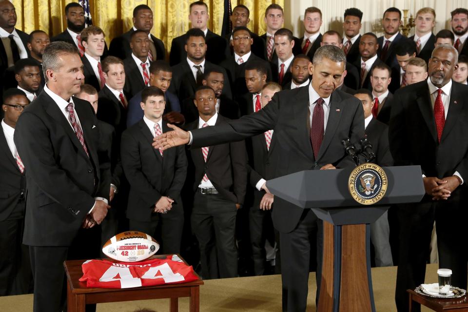 Obama plays host to Meyer and the reigning NCAA football champion Ohio State Buckeyes in a reception in the East Room of the White House in Washington