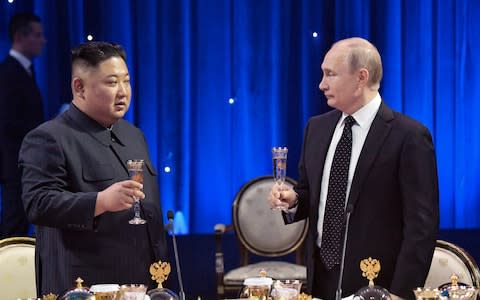 Vladimir Putin and Kim Jong-un toast during the first meeting in Vladivostok in April - Credit: Alexei Nikolsky/Sputnik, Kremlin Pool Photo via AP