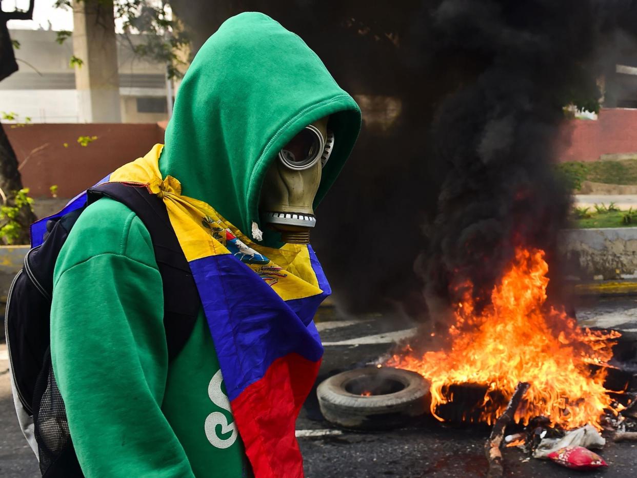 A protester clashes with police in Caracas: Getty Images