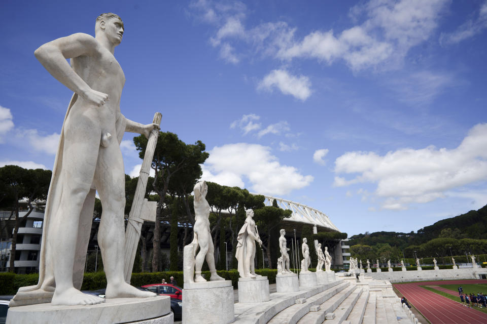 FILE - A marble statue holding a fasces, a bundle of rods tied together around an axe, adopted by Italian dictator Benito Mussolini as a symbol of power, adorns the track and field Stadio Dei Marmi stadium of the Foro Italico, in Rome, Monday, May 6, 2019. The Brothers of Italy party has won the most votes in Italy’s national election. The party has its roots in the post-World War II neo-fascist Italian Social Movement. Giorgia Meloni has taken Brothers of Italy from a fringe far-right group to Italy’s biggest party. (AP Photo/Andrew Medichini, File)