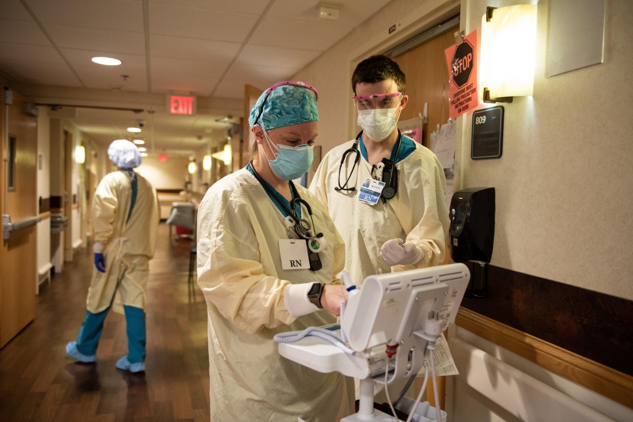 Nurses Elizabeth Nugent and Mason Murphy
work on the COVID-19 floor during the night shift at Benefis Health System