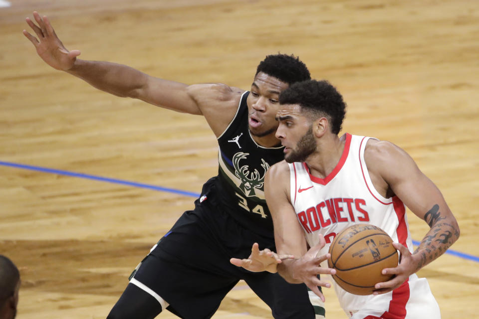 Houston Rockets' Anthony Lamb drives to the basket against Milwaukee Bucks' Giannis Antetokounmpo (34) during the first half of an NBA basketball game Friday, May 7, 2021, in Milwaukee. (AP Photo/Aaron Gash)