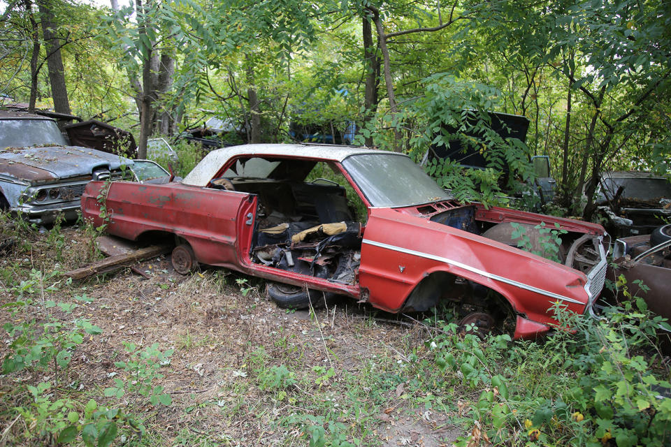 <p>This 1964 Chevrolet Impala two-door hardtop seems to have been propped up on a pair of wheels, likely in an effort to preserve its undercarriage from the ravages of dirt and decay. Unfortunately, this measure came too late, as the floor has already succumbed to <strong>extensive rot</strong>. With little hope of restoration, it's only a matter of time before this car meets its fate in the yard’s crushing pile.</p>