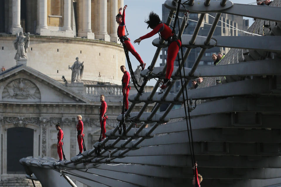 LONDON, ENGLAND - JULY 15: Dancers bungee off the Millennium Bridge as part of the 'One Extraordinary Day' performances on July 15, 2012 in London, England. The dancers are part of American choreographer Elizabeth Streb's 'extreem action' dance group which will perform around London for one day only and form part of the Cultural Olympiad. (Photo by Dan Kitwood/Getty Images)