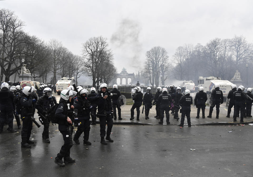 Police set off a water cannon against protestors during a demonstration against COVID-19 measures in Brussels, Sunday, Jan. 23, 2022. Demonstrators gathered in the Belgian capital to protest what they regard as overly extreme measures by the government to fight the COVID-19 pandemic, including a vaccine pass regulating access to certain places and activities and possible compulsory vaccines. (AP Photo/Geert Vanden Wijngaert)