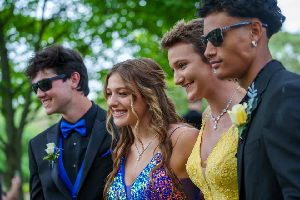 Cade Thompson (right) and Vivian Eagle (second from right) pose Saturday, May 13, 2023, for prom pictures with Cannon Vandever and Eagle's sister, Audrey, at Friendship Gardens Park in Plainfield, ahead of Avon's prom.