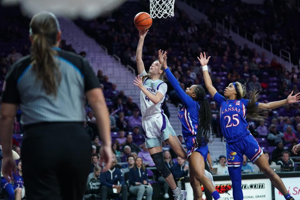 Kansas State guard Serena Sundell (4) drives for a layup against Kansas' Wyvette Mayberry, center, and Chandler Prater during their Sunflower Showdown game on Wednesday night in Bramlage Coliseum.