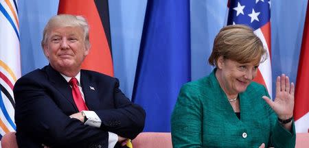 US President Donald Trump (L) and German Chancellor Angela Merkel attend the panel discussion "Launch Event Women's Entrepreneur Finance Initiative" on the second day of the G20 Summit in Hamburg, Germany, July 8, 2017. REUTERS/Patrik STOLLARZ/Pool