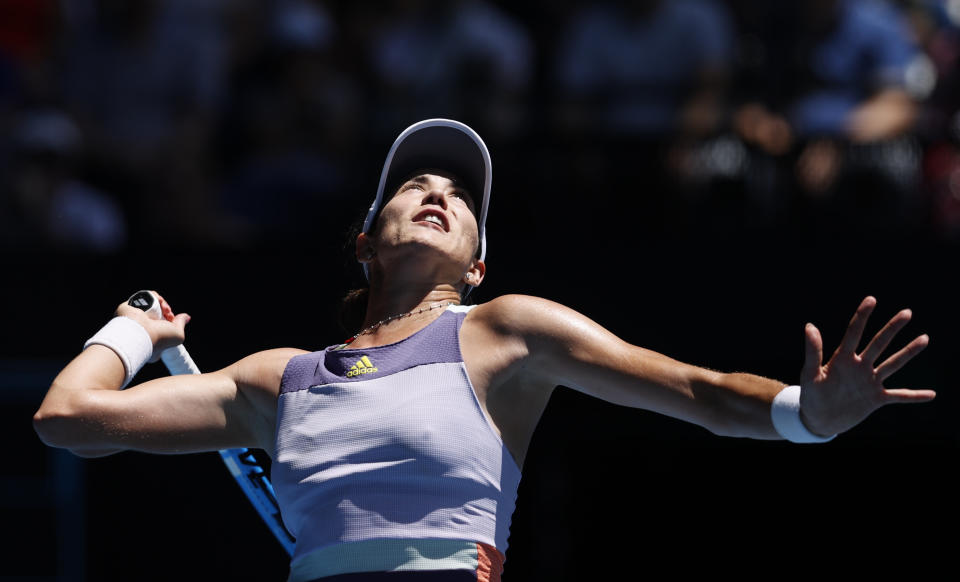 Spain's Garbine Muguruza serves to Russia's Anastasia Pavlyuchenkova during their quarterfinal match at the Australian Open tennis championship in Melbourne, Australia, Wednesday, Jan. 29, 2020. (AP Photo/Andy Wong)