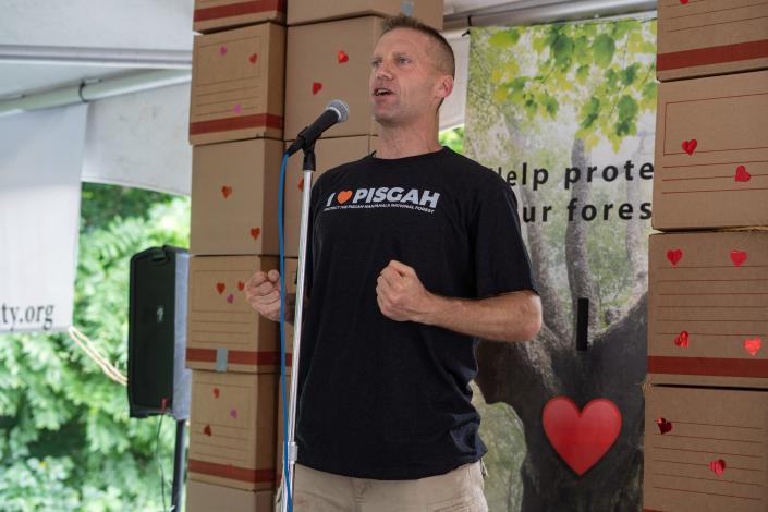 Organizer Will Harlan speaks at the Protect Pisgah Party and Rally outside of the National Forests in North Carolina's Forest Supervisor's office in Asheville on August 1, 2022.