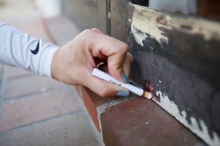 A homeowner uses a home lead test which turns red when it detects the presence of lead on her porch door of her old Spanish style home, valued at more than $1.5 million, and dated from the 1920s, in San Marino, California, United States April 5, 2017. REUTERS/Danny Moloshok