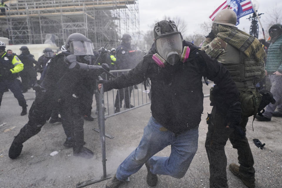 FILE - Insurrectionists loyal to President Donald Trump confront police as they storm the U.S. Capitol on Jan. 6, 2021, in Washington. (AP Photo/Julio Cortez, File)