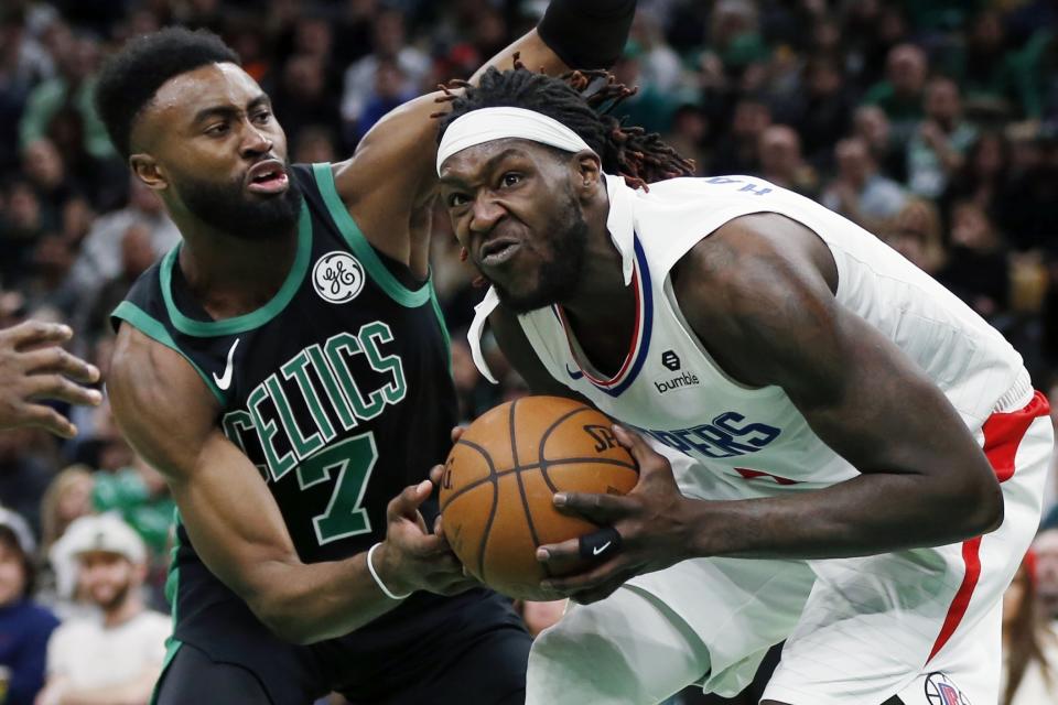 Boston Celtics' Jaylen Brown (7) defends against Los Angeles Clippers' Montrezl Harrell (5) during the second half of an NBA basketball game in Boston, Saturday, Feb. 9, 2019. (AP Photo/Michael Dwyer)
