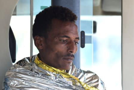 A migrant who jumped off the Spanish rescue ship Open Arms is pictured inside an ambulance in Lampedusa