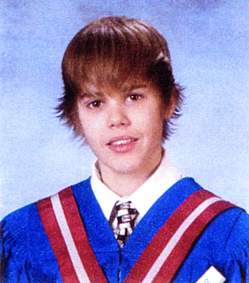 Speaking of the Biebs, the king of the school photos is definitely Justin, who is donning a version of his famous flip-front hairstyle, and what appears to be a graduation gown for his 8th grade portrait. We're here for it.