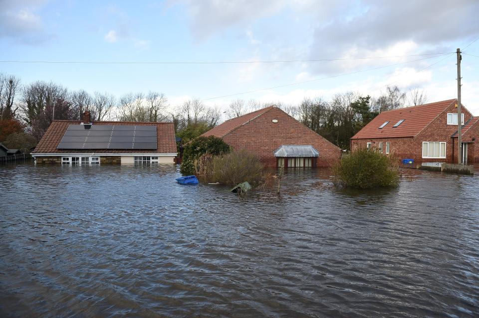 Flood water surrounds houses and residential properties in Snaith, northern England on March 1, 2020 after Storm Jorge brought more rain and flooding to parts of the UK. - Following storms Ciara, Dennis and now Jorge, the record for the UK's wettest February on record has now been  broken, with an 202.1 rain last month, beating February 1990 when 193.4mm fell, the Met Office reported on Sunday. (Photo by Oli SCARFF / AFP) (Photo by OLI SCARFF/AFP via Getty Images)