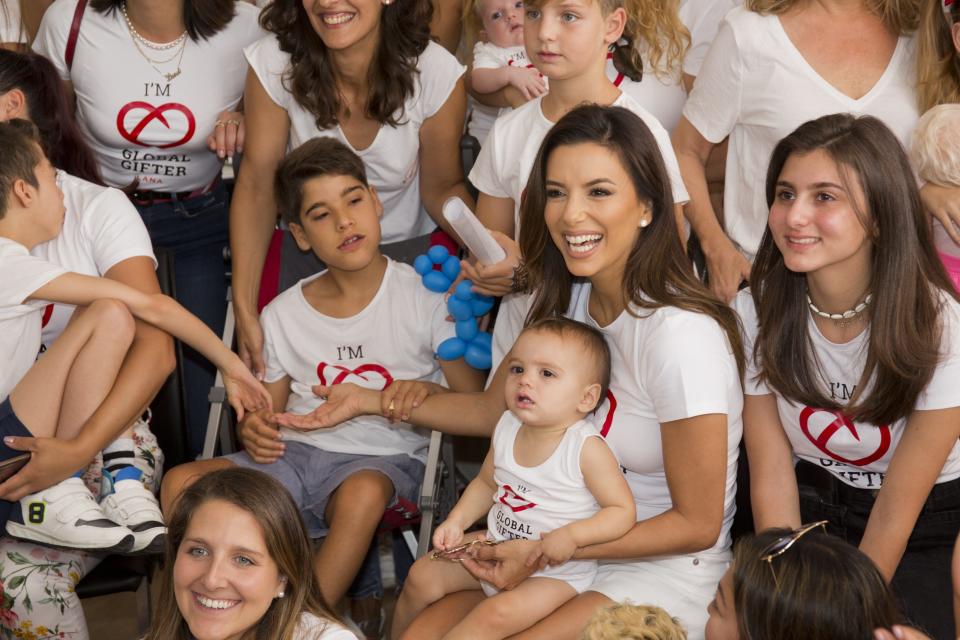 Eva Longoria, with her son Santiago Enrique Bastón on her lap, pictured at the Casa Global Gift presentation during Global Gift Philantropic Weekend 2019 in Marbella, Spain. Longoria shares son Santiago, born in 2018, with her husband José Bastón.