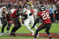 New Orleans Saints tight end Taysom Hill (7) carries against Tampa Bay Buccaneers linebacker Anthony Nelson in the first half of an NFL football game in Tampa, Fla., Monday, Dec. 5, 2022. (AP Photo/Chris O'Meara)