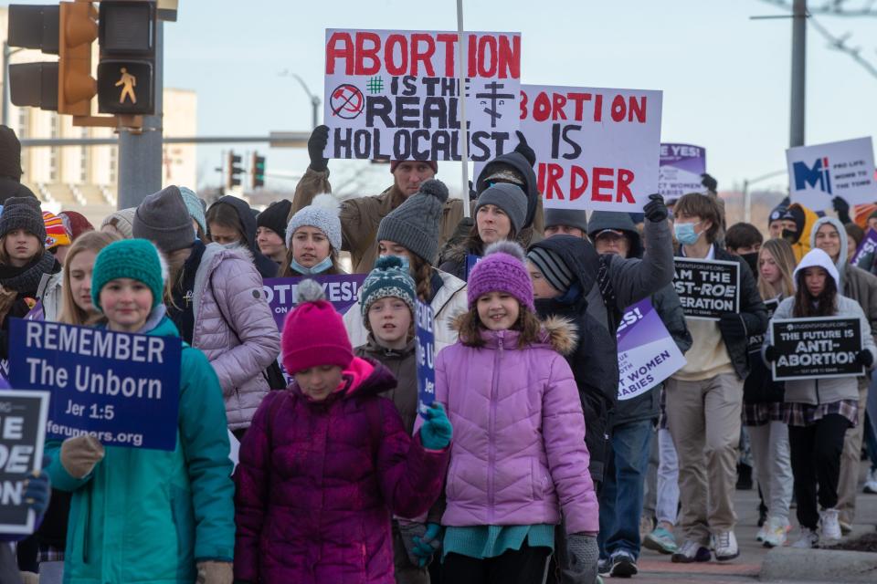 Signs comparing abortion to the Holocaust could be seen among anti-abortion supporters during a Kansans for Life earlier this year through downtown Topeka.